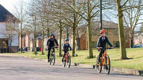Children riding to school with a parent. 