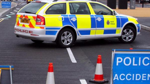 A police car in front of an incident sign
