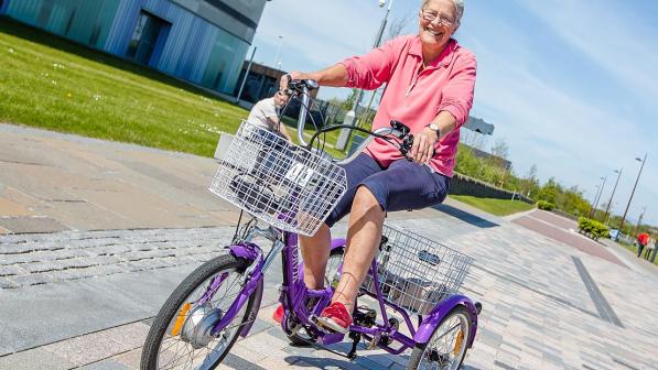 A lady riding a trike during WheelNess Open Day