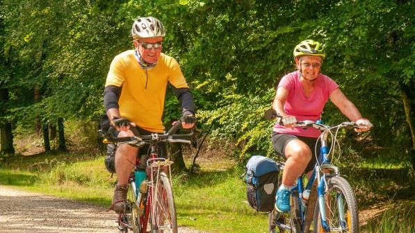 A couple riding in the countryside on a sunny day. 