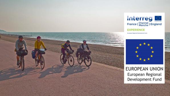 Cyclist riding along a seafront on a sunny evening