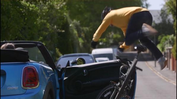 A cyclist being hit by a car door.