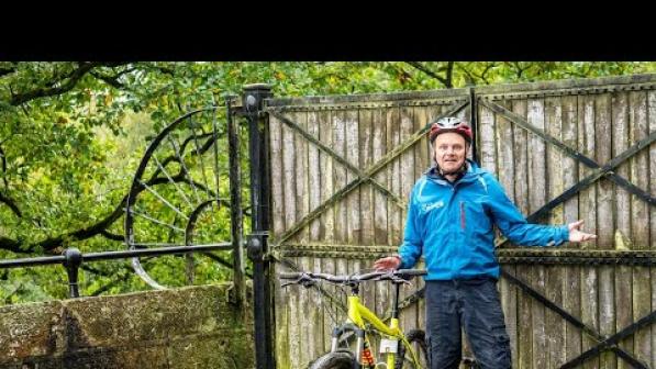 A cyclist standing in front of blocked access