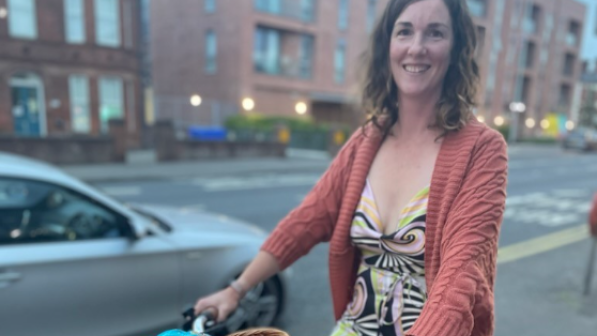 Kerry with her son on a cargo bike while on the road