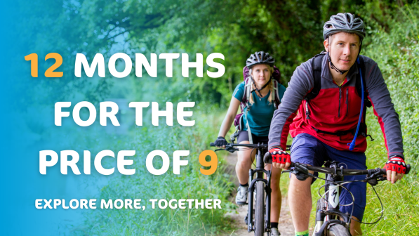 Text reads '12 months for the price of 9. Explore more, together'. The image is two people riding on a leafy path