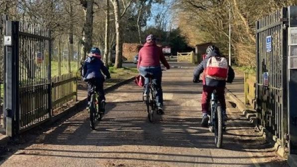 Erica cycling away from the camera with her two children