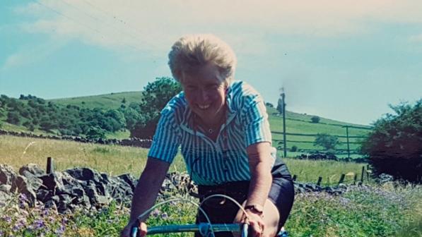 Barbara Else on a bike riding through a field