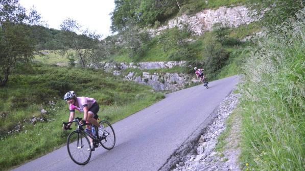 Two cyclists on the road cycling through Cheddar Gorge (c) Chase the Sun