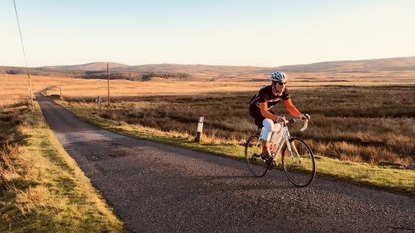 Man cycling on the road through the Scottish borders (c) Graham Dawson/Chase the Sun