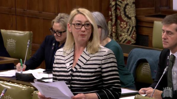 Jess Asato MP, a blonde woman wearing a suit, standing and speaking in Parliament