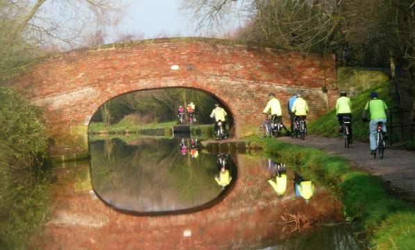Image of Wednesday Riders on Canal Bridge