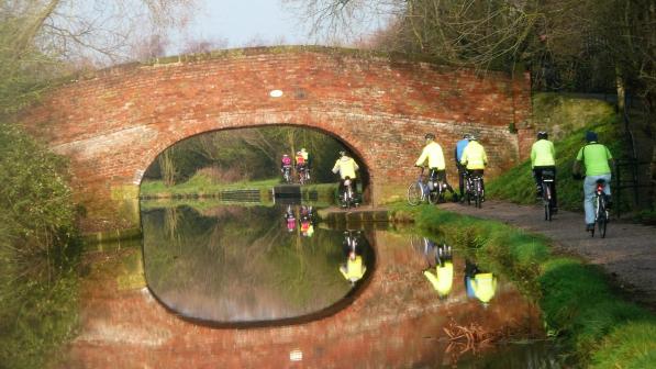 Image of Wednesday Riders on Canal Bridge