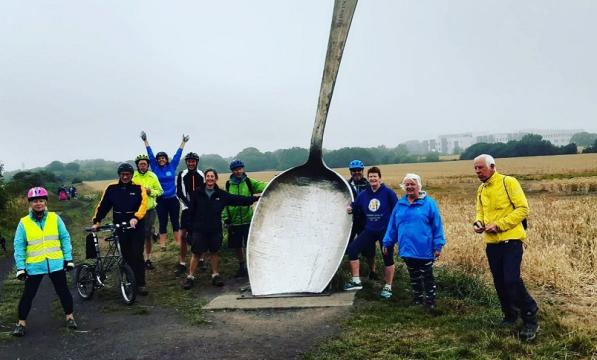 Group ride with giant spoon sculpture