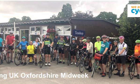 Picture showing about thirty Cycling UK Oxfordshire Midweek cyclists, men and women, just outside a tea room on their bicycles.