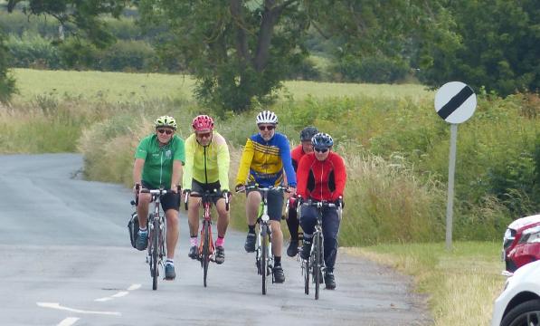 Four Gainsborough Aegir Cycule Club members enjoying a ride on a quiet country road