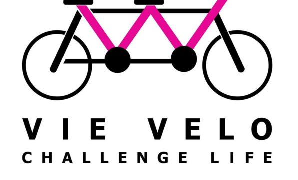 Club logo of a drawing of a pink and black tandem with VIE Velo Challenge Life written underneath