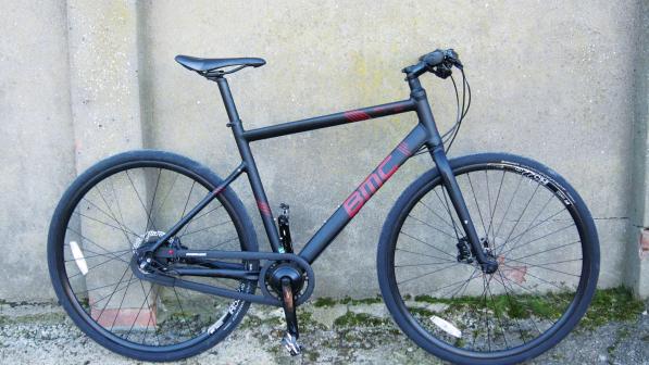 The BMC Alpenchallenge AC02 Nexus, a black city hybrid bike with flat bars and no rack or mudguards