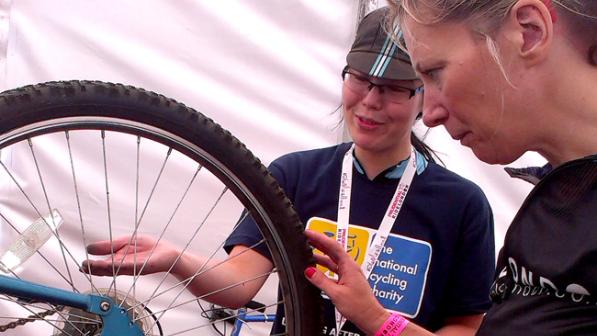 A Dr Bike volunteer fixing a participant's cycle