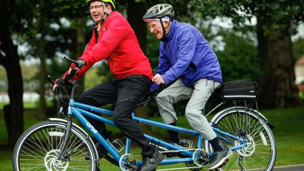 Two men cycling on a tandem